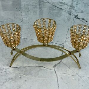 Elegant gold metal like candle holder with beautiful shiny crystal like gems